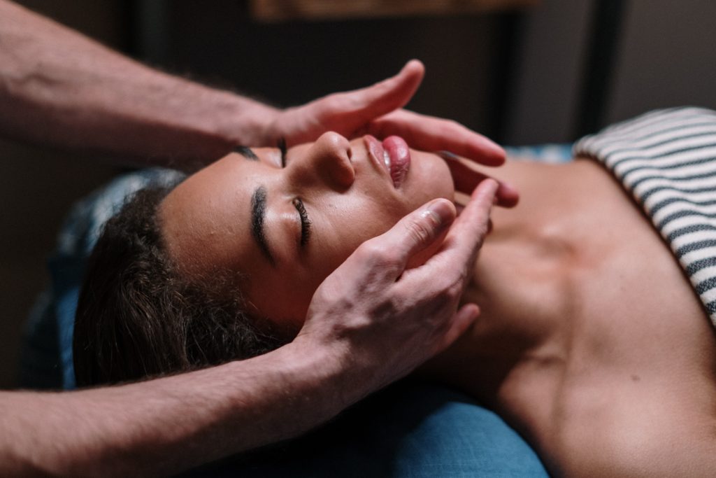 Woman receiving neck massage. Photo by cottonbro studio